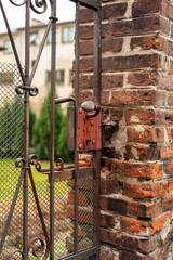old lock at the entrance gate ,old brick wall , Nowy Sącz