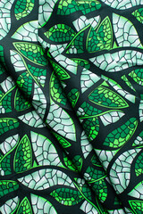 Overhead view of white and green ankara fabric, flatlay of green and white ankara material on a table