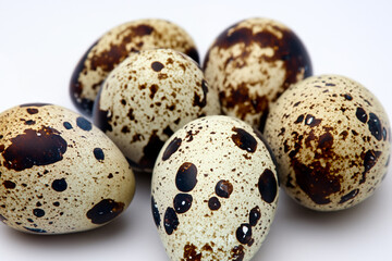 Obraz premium quail eggs. small quail fingers lie on a white background