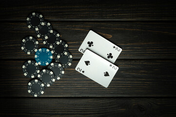 A very popular poker game in America with one pair combination. Chips and cards on a dark vintage...