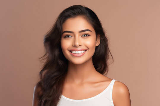young indian woman on pink background.