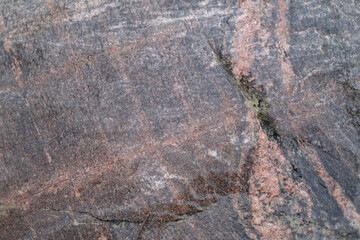 seamless rough granite structure. Gray granite with red veins. Stone structure close up