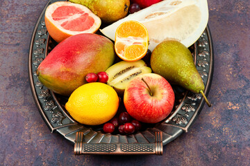 Assortment of fruits on a vintage tray.
