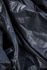 Black plastic garbage bag, black polyethylene texture
