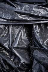 Black plastic garbage bag, black polyethylene texture