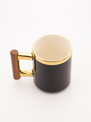 Wooden oak mug with a handle on a gray studio background. Brown mug with ornament. Handmade wooden...