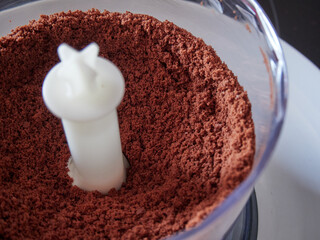 Crushed chocolate cookies to be used as a base in a cheesecake