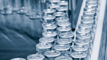 Pharmaceutical industry. Production line machine conveyor with glass bottles ampoules at factory....