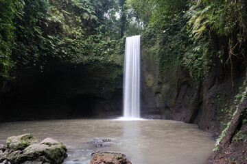 View of Tibumana waterfall on cloudy day. Bali, Indonesia.
