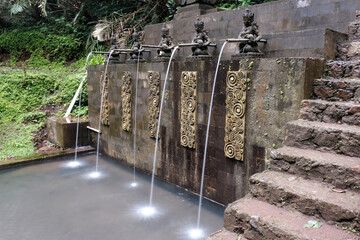 Long exposure shot of a pool for pilgrims nearby Air Terjun Jagasatru waterfall. Bali, Indonesia.