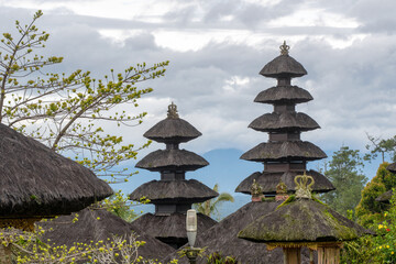 Meru towers of one of Besakih temples on cloudy day. Bali, Indonesia.