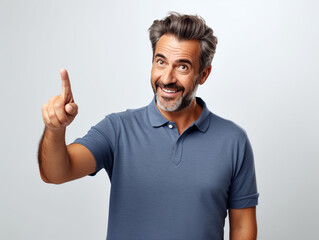 Fototapeta premium A handsome mature man confidently smiling and pointing forward with his index finger
