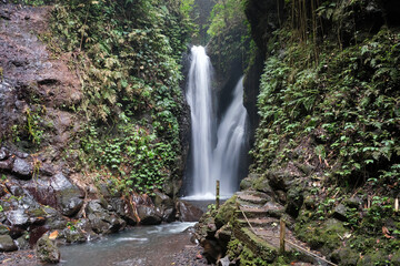 Long exposure shot of Git Git waterfall on cloudy day. Gitgit, Bali, Indonesia.