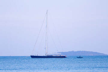 Sailboat and Fishing boats moored in Laem Mae Phim Bay
