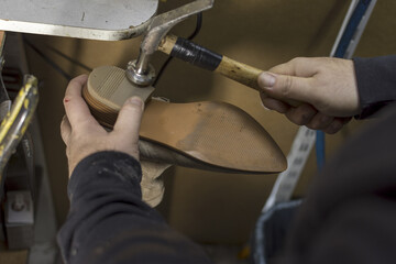 Shoemaker performs shoes in the studio craft