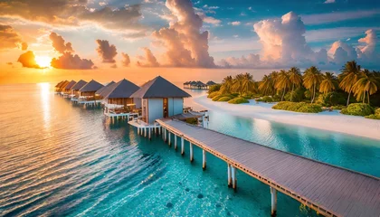 Poster sunset on maldives island luxury water villas resort and wooden pier beautiful aerial sky clouds and beach background summer coast vacation travel paradise sunrise landscape pristine sea bay © Ashley