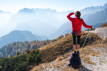 Woman Tourist Looking Far Away in Beautiful Mountains Landscape Environment of European Alps - obrazy, fototapety, plakaty
