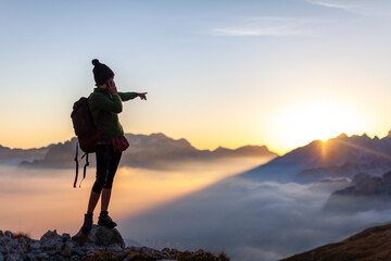 Woman Hiker Asking for Direction Navigation Tips trough her Smart Phone from High Mountains of...