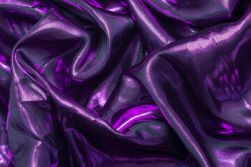 Abstract wrinkled dark purple fabric. Shiny luxury cloth texture for the background