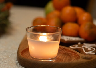 Christmas composition with candle and tangerines