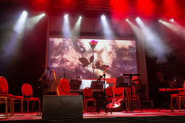 Preparing for the concert performance - stage with musical instruments under bright spotlights