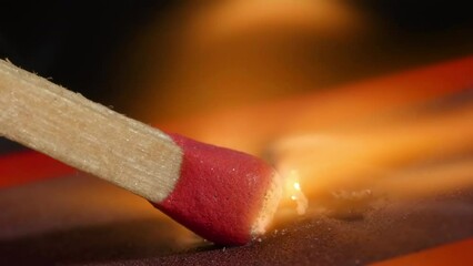 4K - a matchstick burning with matchbox. Extreme close-up