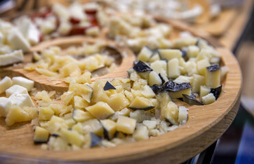 various cheeses for tasting on a wooden plate