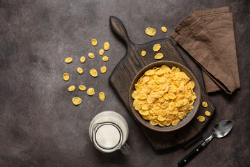 Healthy breakfast. Corn flakes with milk on a dark background. View from above.