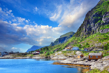 Beautiful sunrise over Hamnoy, fishermen village with the typical red houses of the Lofoten...