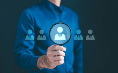 HRM or Human Resource Management, Magnifier glass focus to manager icon which is among staff icons for human development recruitment leadership and customer target group concept.
