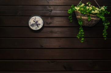 round wall clock on dark wooden background