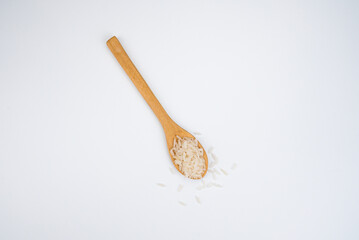 rice in wood spoon isolated on white background