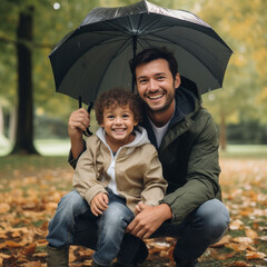 Father and son with umbrellas in the park.