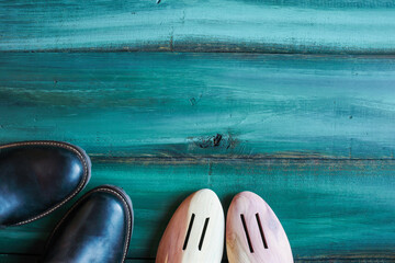 Men's leather dress shoes with cedar wood shoe trees shot from table top view. Overhead image. 