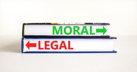 Moral or legal symbol. Concept word Moral or Legal on beautiful books. Beautiful white table white...