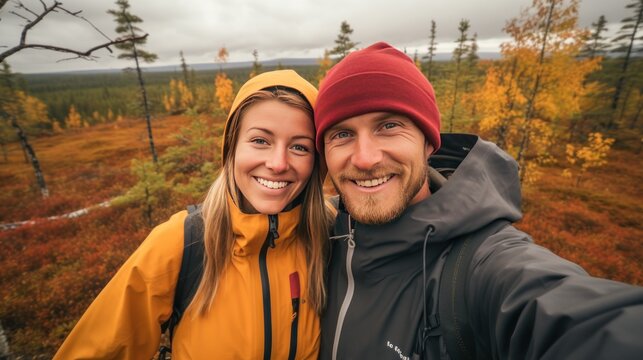 Couple taking a selfie on a hike in the autumn forest.
