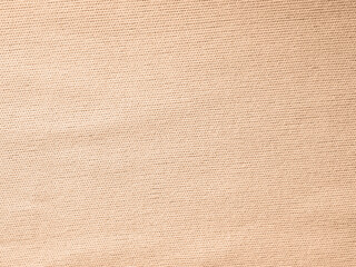 Factory textile fabric material surface peach light colored background with thread