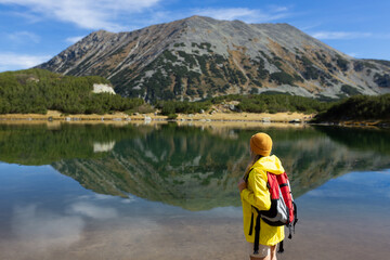 Woman tourist enjoying lake view alone outdoors Travel adventure in active holiday healthy lifestyle eco tourism