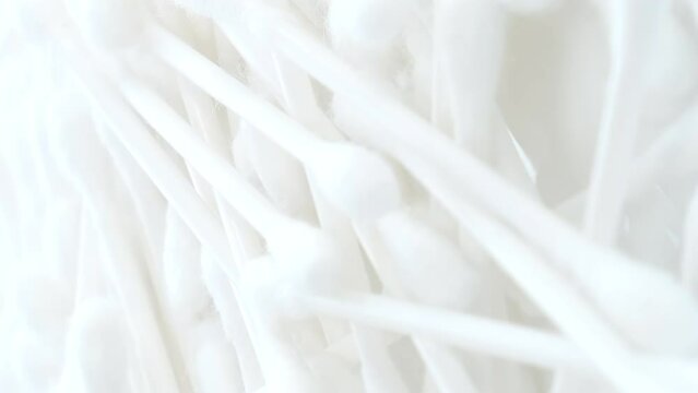 White cotton swabs, cotton swab on a clean white background. Vertical video