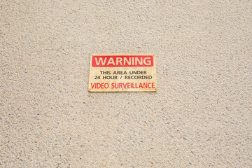 Warning 24 Hour Video Surveillance sign on the wall
