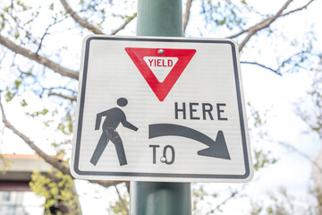 USA traffic road signs. yield here to pedestrians crossing