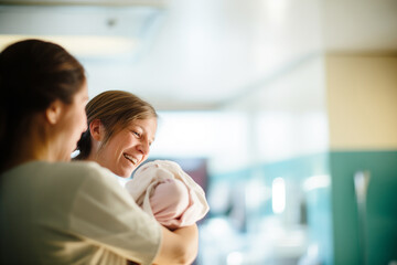 Mother with Newborn and Nurse in Hospital