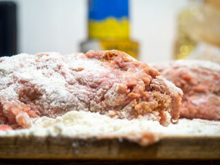 A piece of minced chicken in flour. Meat after the meat grinder. Cooking cutlets. Minced meat close-up.
