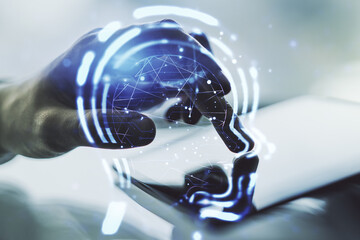 Creative artificial Intelligence concept with human head hologram and finger clicks on a digital tablet on background. Multiexposure