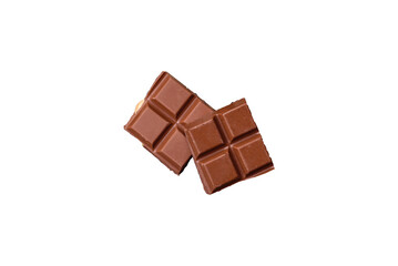 Delicious sweet milk chocolate broken into cubes on a wooden cutting board