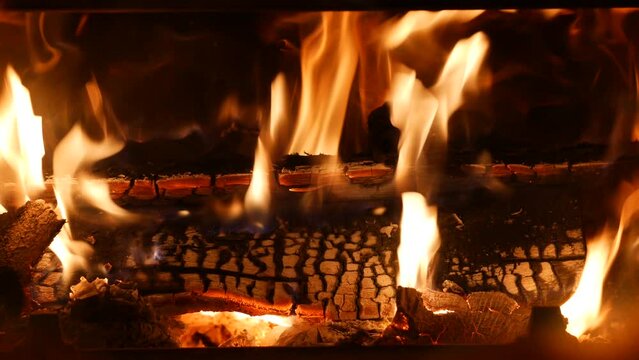 Wood burning in a cozy fireplace at home