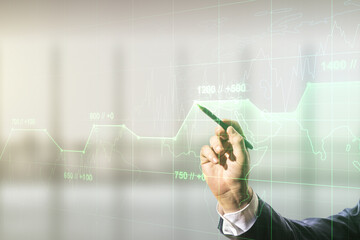Double exposure of male hand with pen working with abstract virtual statistics data hologram on blurred office background, statistics and analytics concept