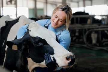 Concept agriculture cattle livestock farming industry. Farmer Happy young woman hugging cow,...