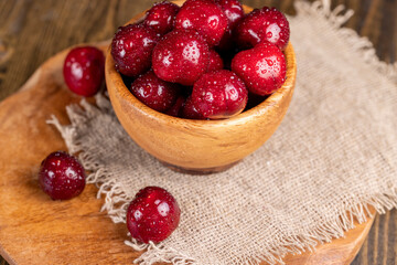 covered with drops of water ripe red cherries on the table