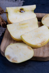 crushed dark yellow apple with cinnamon on the table